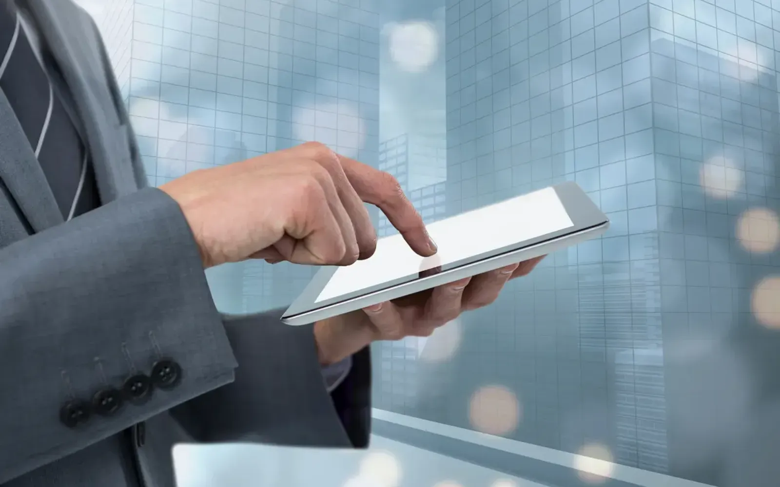 Tablet mit digitalem Grundriss neben einem Hausmodell - moderne Immobilienvermarktung