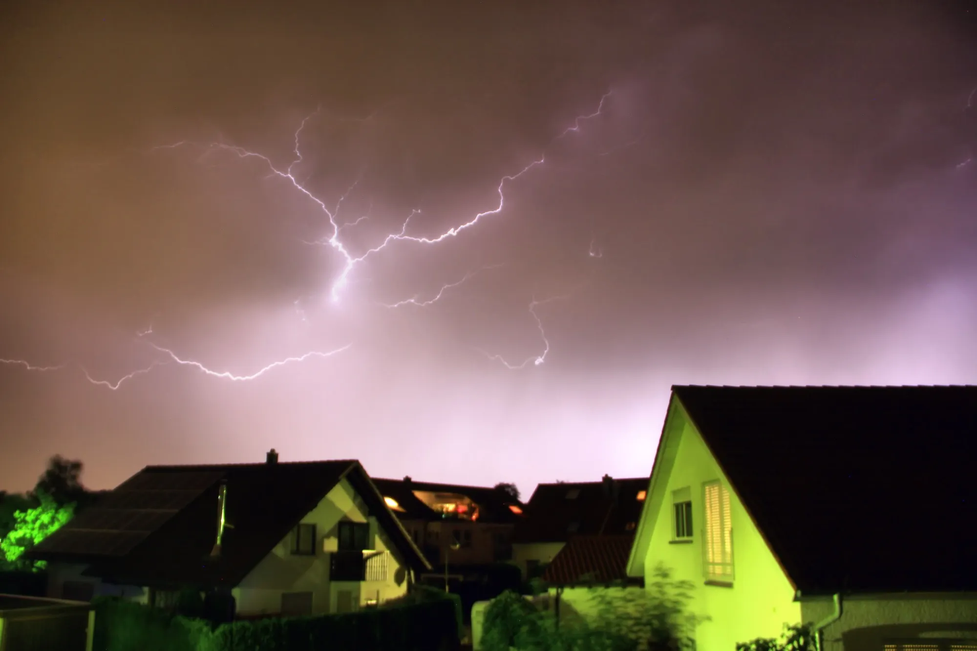 Lightning striking residential buildings at night - professional lightning protection for buildings in Nuremberg